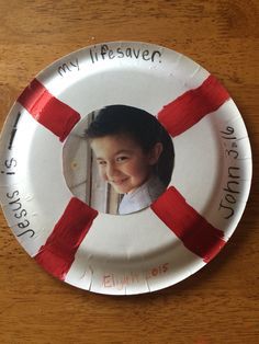 a paper plate with an image of a child's face and red tape around it