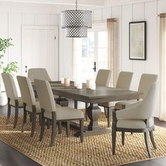 a dining room table with chairs and a rug