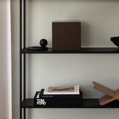 a black shelf with books and other items on it