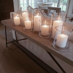 a long table with many lit candles on it