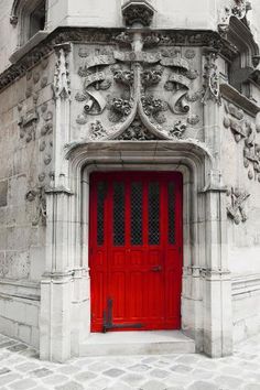 an old building with a red door and window