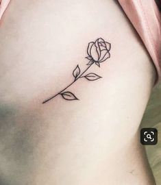 a small rose tattoo on the side of a woman's right thigh and lower back