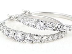 Bella Luce ® white diamond simulant 4.00ctw round, rhodium over sterling silver hoop earrings. Measure approximately 1.13"L x 0.13"W and have saddleback backings. The diamond equivalent weight is 2.28ctw. Round Cubic Zirconia Hoop Earrings Fine Jewelry, White Cubic Zirconia Hoop Diamond Earrings, Cubic Zirconia Fine Jewelry Hoop Earrings, Cubic Zirconia Hoop Earrings Fine Jewelry, White Cubic Zirconia Hoop Earrings, White Cubic Zirconia Hoop Earrings With Diamond Cut, Dazzling White Round Cut Hoop Earrings, Brilliant Cut Cubic Zirconia Hoop Earrings, Classic White Cubic Zirconia Hoop Earrings