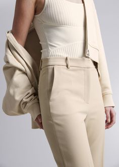 High-waist trousers featuring a kick-flare, angle-length silhouette. Finished with press creases.Zip fly with button closureSlanted side pocketsWelt back pocketsLength of inseam: 69.5cm / 27.4" (EU 36 / UK 8 / US 4) Modern Fitted Pants With Zipper Closure, Chic Beige Elastane Pants, Fitted Solid Bottoms With Zipper Closure, Fitted Bottoms With Zipper Closure In Solid Color, Fitted Bottoms With Zipper Closure, Modern Bottoms With Zipper Closure For Spring, Modern Structured Bottoms For Spring, Fitted Flare Beige Pants, Modern Spring Bottoms With Zipper Closure