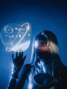 a woman in latex holding up a glowing object