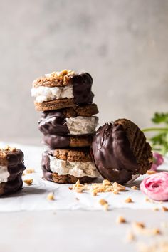 a stack of cookies with chocolate frosting and nuts