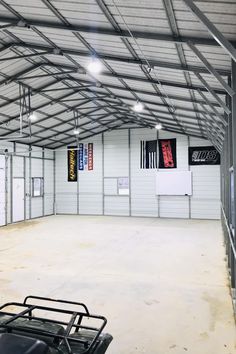 an empty garage with two atvs in it