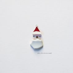 a white santa claus ornament hanging on a wall