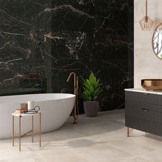 a bathroom with marble walls and flooring next to a bathtub, sink and mirror