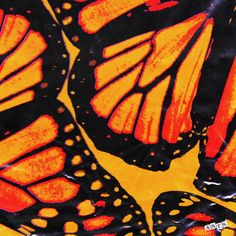 an orange and black butterfly pattern on a yellow background