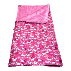 a pink sleeping bag with horses on it