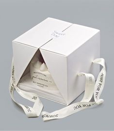 a white box with a ribbon around it