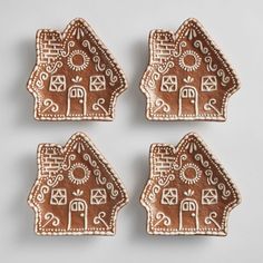 four ginger cookies with designs on them