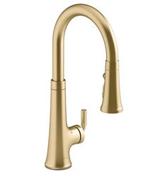 the delta single handle pull - down kitchen faucet in brushed brass with an angled spout