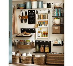 the shelves are organized with baskets and kitchen utensils