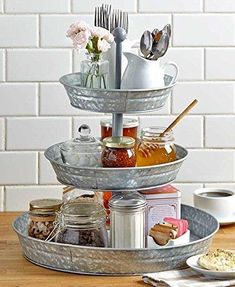 three tiered tray with utensils and jars