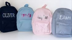 four backpacks with the word love written in different colors and font on each one