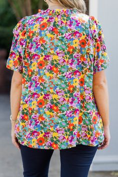 Add a touch of playful charm to your wardrobe with this top! Featuring a v-neckline with tied detail, short puff sleeves, and ruffled detailing, this top is adorned with a bold floral print! Perfect for pairing with denim or pants, it's sure to make you feel effortlessly stylish! 100% Rayon Spring Floral Print Tops With Flutter Sleeve, Cotton Blouse With Floral Print And Ruffle Sleeves, Cotton Ruffle Sleeve Tops With Floral Print, Cotton Top With Floral Print And Ruffle Sleeves, Cotton Tops With Ruffle Sleeves And Floral Print, Cotton Tops With Floral Print And Ruffle Sleeves, Spring Floral Print Flutter Sleeve Blouse, Multicolor Cotton Ruffle Sleeve Tops, Multicolor Cotton Top With Ruffle Sleeves