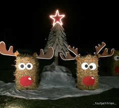 three hay wrapped reindeers are standing in front of a christmas tree with a star on top