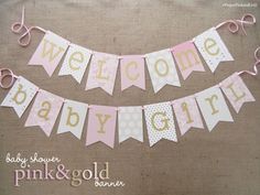 a pink and white banner that says welcome baby