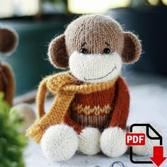 a knitted monkey sitting on top of a table next to a potted plant