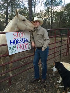 a man standing next to a fence with a horse and dog in front of him