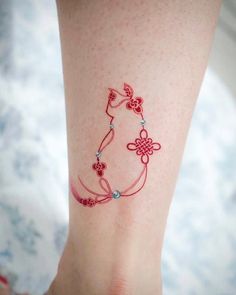 a woman's leg with a tattoo on it that is decorated with flowers and hearts