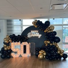 a large balloon arch with the number 50 on it