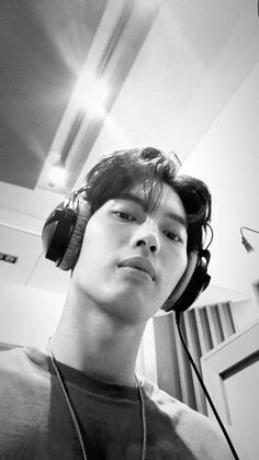 a young man wearing headphones and listening to music