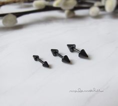 * Surgical steel spike stud earrings. Barbell screw style. * This price is for a set of 3 pieces. You will get 1 piece of each size (3,4,5mm) * These earrings are made of 316L surgical grade stainless steel. IP plating (no fading). * Choose from 2 styles: Spike/Spike - or - Spike/Ball * Available Color: Black and Platinum * Dimensions : Spike 3, 4, and 5 mm , Post gauge 18G (1mm) 6 mm in length **Measurements are an approximation. Size, shape and color can vary slightly from above dimensions.** Black Metal Punk Cartilage Earrings, Helix Spikes, Black Surgical Steel Single Earring, Edgy Metal Earrings With Spikes, Spike Earrings Studs, Ribbon Box, Titanium Earrings, Spike Earrings, Helix Earrings