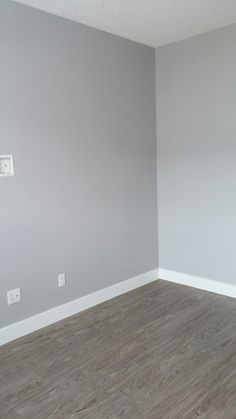 empty room with hard wood flooring and white paint on the walls in an apartment