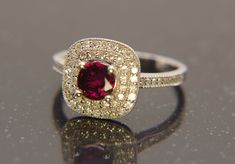 Ladies Gem Grade Ruby and Diamond Ring, 14k White Gold Setting, Double Halo - This offering features a natural round cut Corundum (Ruby), weighing 0.88 carats and measures 5 1/2 mm in diameter. This is a beautiful deep red, pigeon blood colored stone. I've had this stone in my collection for over 40 years. The double halo of full cut diamonds weight approximately 0.38 carats. The diamonds will grade SI and h/I color. The 14k yellow gold setting features an open filigrees pattern and is size 6 1/ Ruby And Diamond Ring, Filigree Pattern, Tanzanite Ring, Colored Stone, Double Halo, Yellow Gold Setting, Ring Photos, Deep Red, Rings Statement