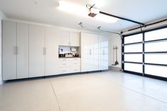 an empty room with white cabinets and sliding glass doors