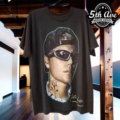 a t - shirt with the image of elvis presley on it hanging from a rack