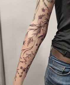 a woman's arm with flowers on it, and an arrow in the middle