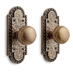 two antique style door knobs with decorative designs