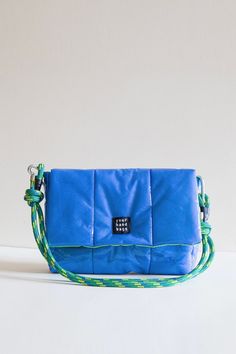 The outer surface of the Blue Candy bag is quilted with colored vinyl material and fiber. The inside of the Blue Candy Bag is light green lined. The strap of the bag is made of rope material. The strap is adjustable. It can be used as a shoulder bag and a crossbody bag. The strap is interchangeable. Product Dimensions 11*7*2 Trendy Blue Shoulder Bag For Outdoor, Trendy Blue Outdoor Bags, Blue Outdoor Shoulder Bag With Adjustable Strap, Blue Nylon Shoulder Bag With Detachable Strap, Blue Shoulder Bag For Outdoor, Blue Nylon Pouch Bag, Blue Quilted Nylon Bags, Blue Crossbody Shoulder Bag For Outdoor, Blue Nylon Crossbody Shoulder Bag