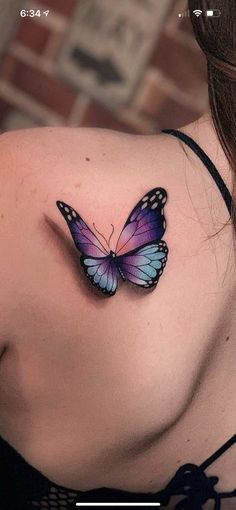 a woman with a butterfly tattoo on her shoulder