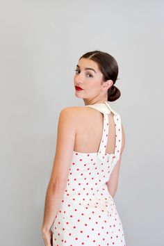 "Embody the 1960's-70's with this youthful and fun polka dot dress! This dress hugs the body so well while still being comfortable. Wear to your next party with a bold red lip, and red or black kitten heels. Or, opt to dress down and layer beneath a coat with white sneakers. The dress fastens in the back with a zipper and a snap button behind the neck. It is 100% cotton. The dress is in great vintage condition. Please see measurements to confirm sizing. Measurements: Length: 51.5\" Bust: 30\" Wa Fitted 1950s Style Polka Dot Dress, Fitted Polka Dot Dress In 1950s Style, Summer Pinup Dresses For Party, Summer Pinup Party Dresses, Summer Party Pinup Dresses, Polka Dot Pinup Dress For Summer, Summer Pinup Polka Dot Dress, Summer Polka Dot Pinup Dress, Pinup Polka Dot Dress For Party