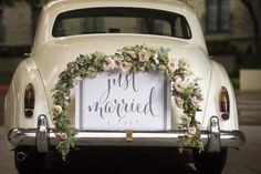 an old car with a sign that says just married