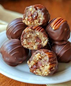 chocolate covered candies on a plate with pecans