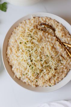 a bowl of oatmeal topped with parmesan sprinkles