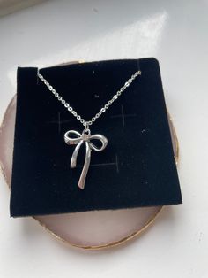 A beautiful bow necklace on an 44cm silver trace chain size of bow is 2cm x 2.6 cm silver colour alloy charm Classic Silver Jewelry With Bow, Silver Bow Jewelry, Luxury Silver Jewelry With Bow Detail, Luxury Silver Bow Jewelry, Silver Bow Necklace, Hair Tie Accessories, Pretty Jewelry Necklaces, Ribbon Jewelry, Bow Necklace