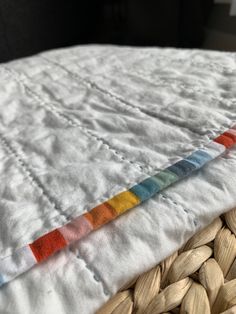 a close up of a bed with a quilt on top of it and some nuts in the bottom