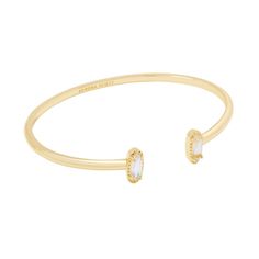 Looking for a pop of sparkle to add to your wrist stack? Meet the Emma Cuff Bracelet, aka your new style essential. Two elongated stones bookend this adjustable metal cuff you can fit to your wrist perfectly. On-trend and oh-so-cute, you'll style this bracelet time and time again. Designer, founder, and philanthropist Kendra Scott started her company in 2002, just three months after her first son was born. Her commitment to innovation, quality, customer service, and detail has taken her from a s Kendra Scott Bangle, Old Money Bracelet Stack, Kendra Scott Cuff Bracelet, Gold Bracelet Stack, Gold Bracelet Bangle, Wrist Stack, Kendra Scott Bracelet, Wrist Stacks, Gold Cuff Bracelet