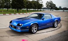 a blue sports car parked in a parking lot