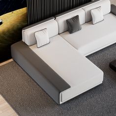 a white couch sitting on top of a gray floor next to a tv remote control