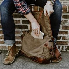 This traditional sized vintage military messenger bag is crafted from waxed canvas with leather accents. Perfect for your laptop, meeting materials, and your copy of Harrison & Kooser’s Braided Creek (to read during your meeting). mens bags | leather | canvas | crossbody satchel | gifts for him #mensguides #menswear Rugged Fashion, Military Messenger Bag, 1940's Style, Mens Rugged, Leather Messenger Bag Men, Lifestyle Photoshoot, Waxed Canvas Bag, Canvas Leather Bag, Army Surplus