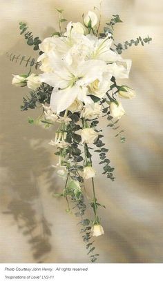 a bouquet of white flowers and greenery