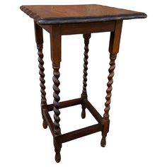 an old wooden table with two legs and a small square top on one end, sitting against a white background